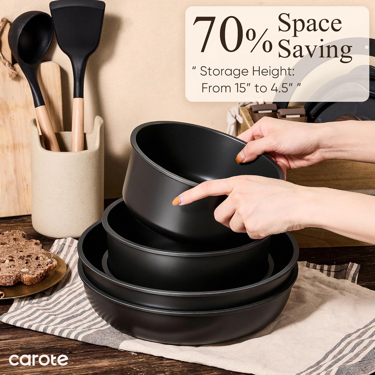Three pans stacked inside one another on a kitchen worktop, hands lifting the top one